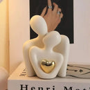 Estatua pareja abrazo romántico con corazón dorado en decoración de dormitorio