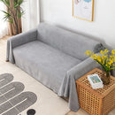 Funda impermeable para sofá gris antideslizante en living minimalista y prolijo