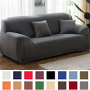 Funda de sofá elástica gris en living moderno luminoso