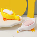 Jabonera pato autodrenante en amarillo y blanco con jabón sobre mesada de baño