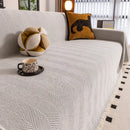 Manta cubre sofá jacquard espiga blanca con flecos en living luminoso