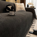 Manta cubre sofá jacquard espiga gris oscuro con flecos en living moderno